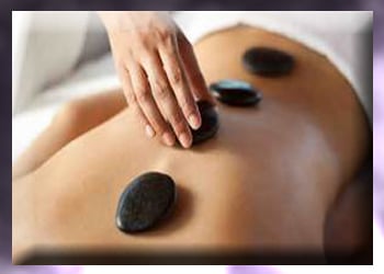 Basalt stones placed on woman's back for hot stone therapy