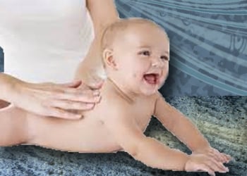 happy, naked baby propped up on its hands while Mom massages the back