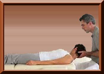 Woman lying on table receiving chiropractic adjustment from chiropractor